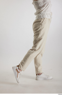 Yeva  1 beige pants casual dressed flexing leg side…